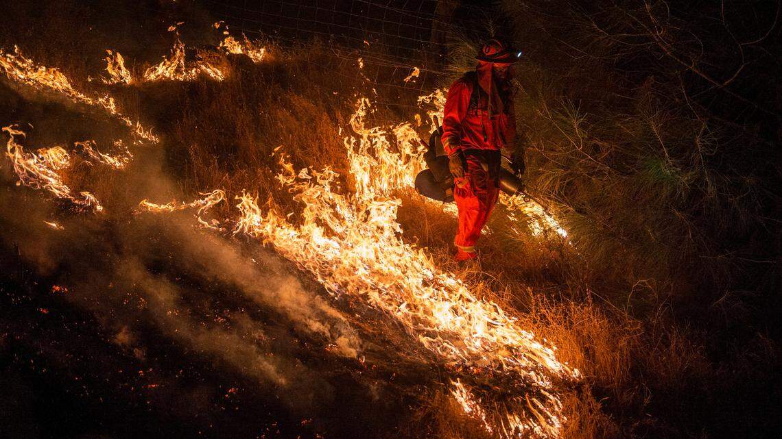 An inmate firefighter sets a backfire at the Sites Fire in Colusa County on Sunday, August 2, 2020. 