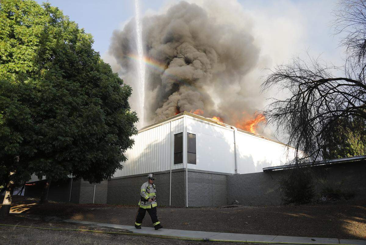 San Jose Fire Department firefighters battle a three-alarm fire at the Public Storage facility at 88 Blossom Hill Road in south San Jose on June 14, 2023. The fire was later determined to have been caused by illegal fireworks.