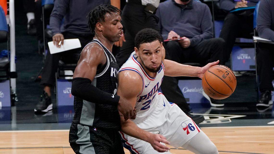 Philadelphia 76ers guard Ben Simmons, right, drives against Sacramento Kings guard Buddy Hield, left, during the first half of an NBA basketball game in Sacramento, Calif., Tuesday, Feb. 9, 2021. (AP Photo/Rich Pedroncelli)