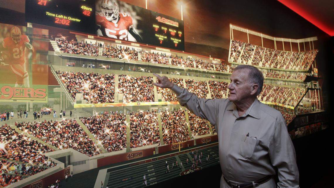Retired San Francisco 49ers General Manager John McVay shows off where he would like to sit at the planned new home of the 49ers at the Preview Center in Santa Clara, Calif., Tuesday, Sept. 27, 2011.