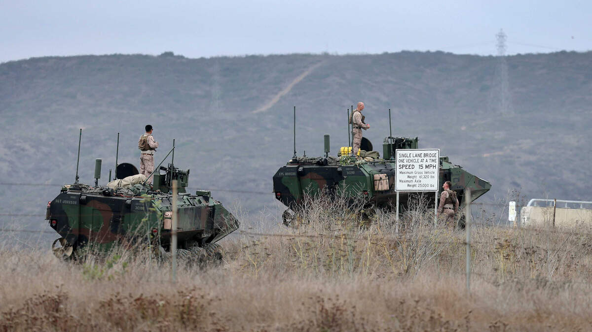 Marines stand atop armored vehicles at Camp Pendleton in San Diego County in September. A 17-mile stretch of Interstate 5 near the base was briefly closed Saturday before a live-fire demonstration tied to the Marine Corps’ 250th anniversary celebration.