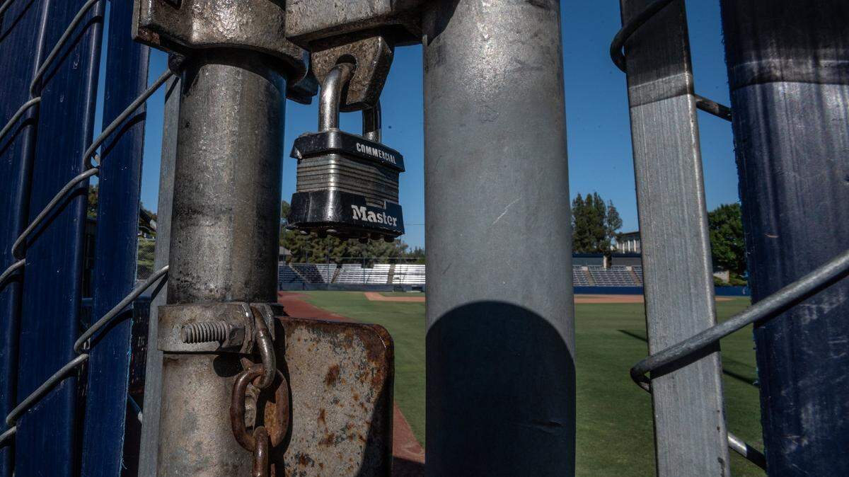 The gate is locked at Swimley Field, home of the UC Davis baseball program, on Thursday, July 15. The program has been suspended, and its coaches placed on leave, by the school’s athletic department.