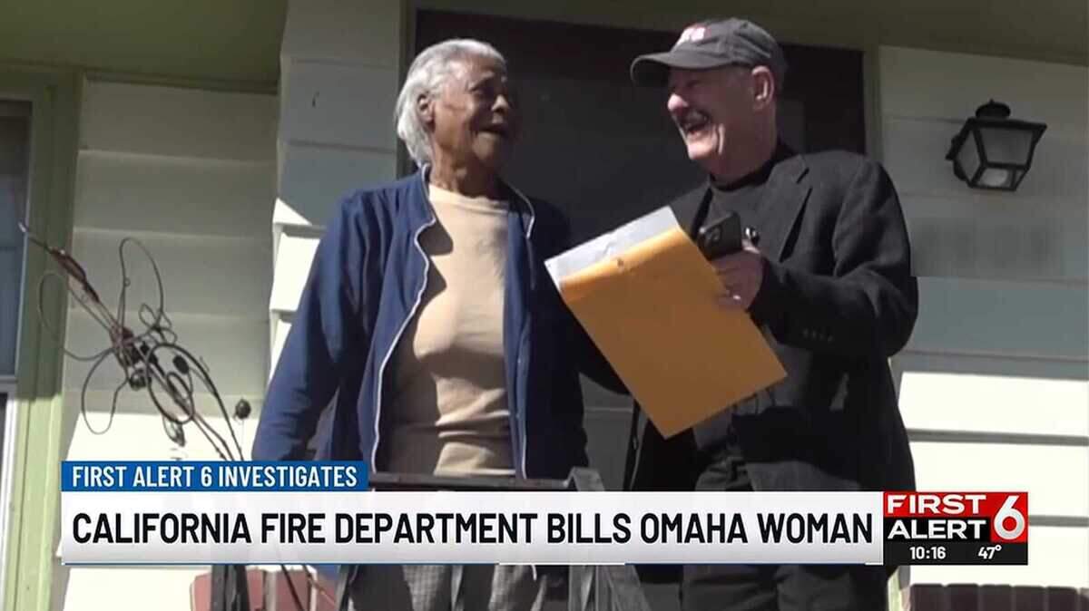 Linda Johnson stands on her front porch March 4, 2026, with reporter Mike McKnight during a TV report for First Alert 6 in Omaha, Neb., about Johnson receiving a first-responder bill from Roseville, Calif. — a city she has never visited. The bill was later voided.