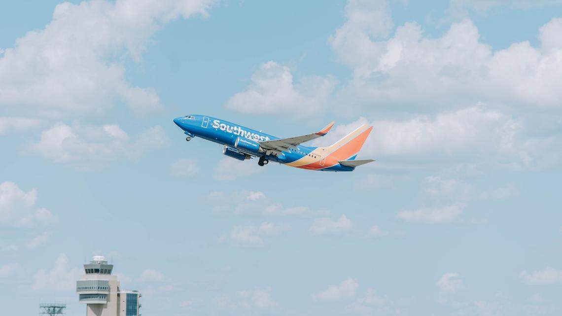 A passenger’s photo shows a pilot climbing through a cockpit window into a Southwest Airlines jet at the San Diego airport in California.