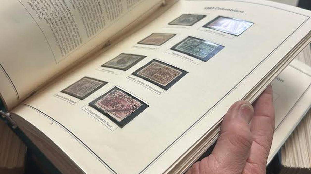 Ed Dimmick, a member of the board of directors for the Sacramento Philatelic Society, flips through a stamp album on Sunday.