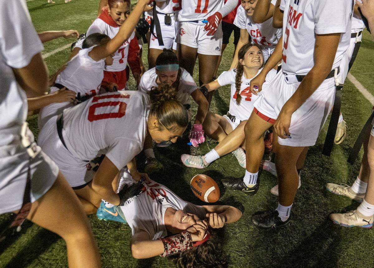 McClatchy Lions quarterback Daisy Throckmorton (24) celebrates with her teammates following the CIF Sac-Joaquin Section Division I flag football championship game against the West Park Panthers on Saturday at Cosumnes River College in Sacramento.