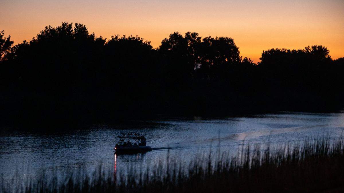 Boaters head south on the Sacramento River, north of Locke, through the Sacramento-San Joaquin Delta on July 23, 2021.