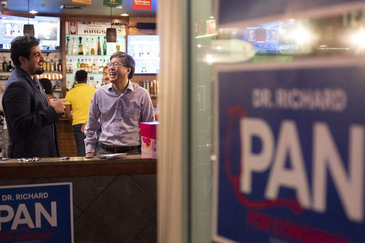 Former state Sen. Richard Pan, a candidate for the 6th Congressional District, speaks to supporter and Citrus Heights resident Adam Hatefi during his election night party at Frends Brewhouse in South Natomas on Tuesday.