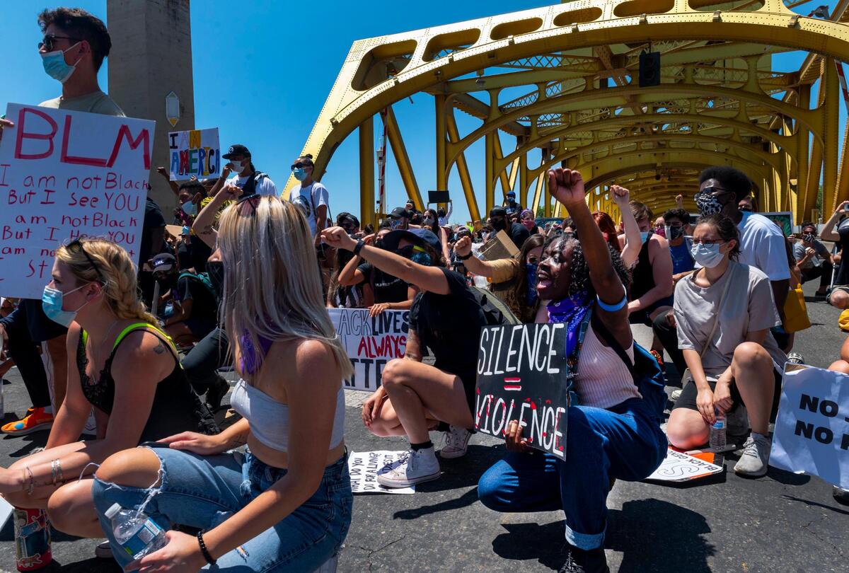 16. Mistique Davis, of Stockton, stops after crossing the Tower Bridge in Sacramento to join other demonstrators in shouting the names of Black men and women killed by police at the Youth March 4 Black Freedom on Saturday, July 4, 2020.