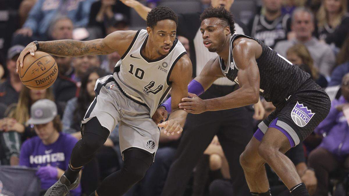 San Antonio Spurs guard DeMar DeRozan, left, drives against Kings guard Buddy Hield on Monday at Golden 1 Center. DeRozan said some positive words about the Kings after his Spurs lost 104-99.