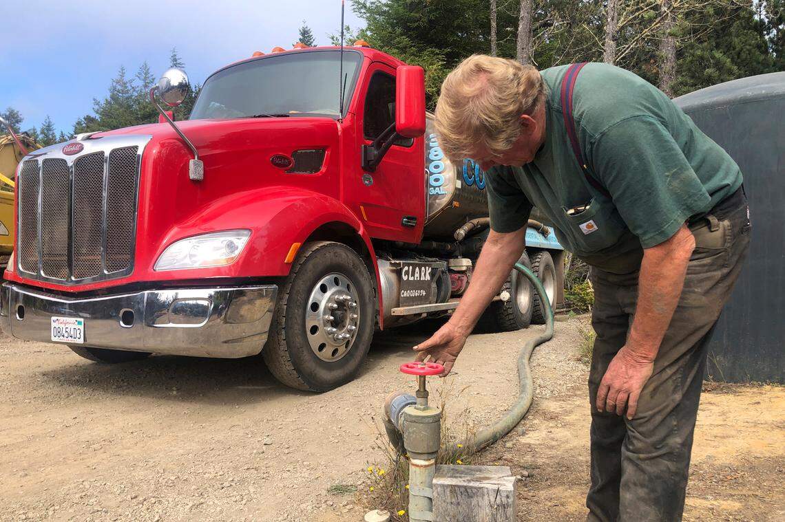 Brian Clark fills his water truck in Little River on Aug. 4. Tourists flock to the picturesque coastal town of Mendocino for its Victorian homes and cliff trails, but visitors this summer will also find public portable toilets and dozens of signs on picket fences announcing the quaint Northern California hamlet: “Severe Drought Please conserve water.” Clark has been selling water from his well outside of town and trucking it to the people who need it, but he said he can’t keep up with the demand.