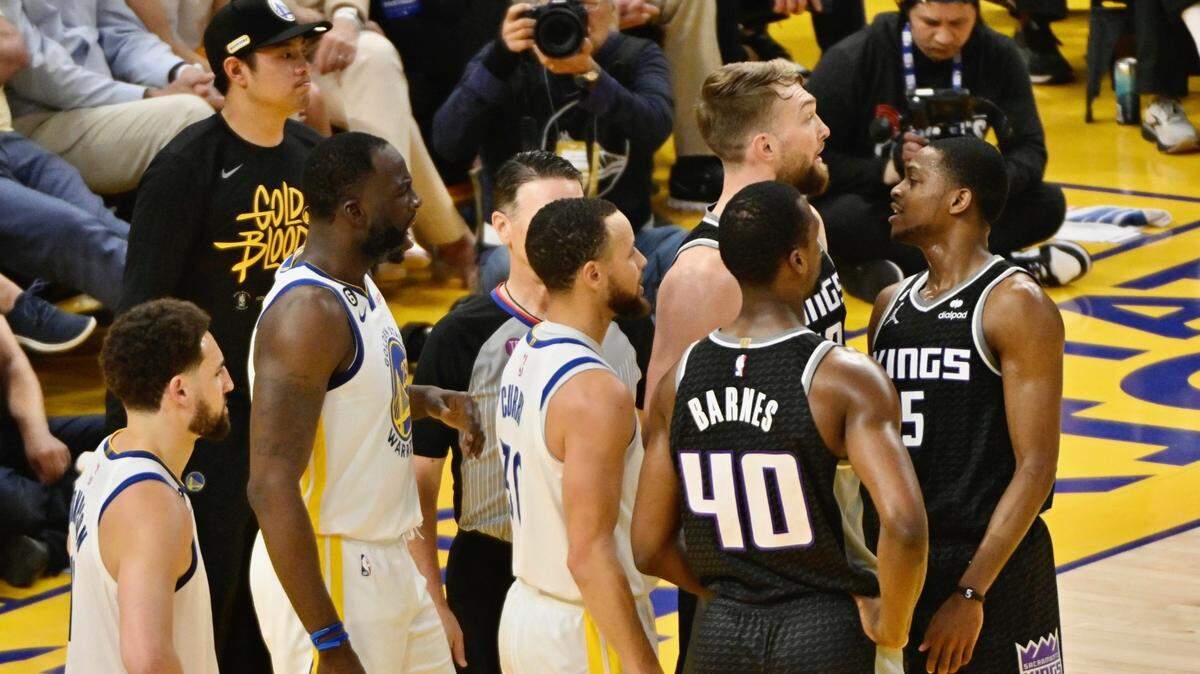 Sacramento Kings guard De’Aaron Fox and the Golden State Warriors’ Draymond Green exchange words during the first quarter of Game 4 of the first-round NBA playoff series at Chase Center in San Francisco on Sunday, April 23, 2023.