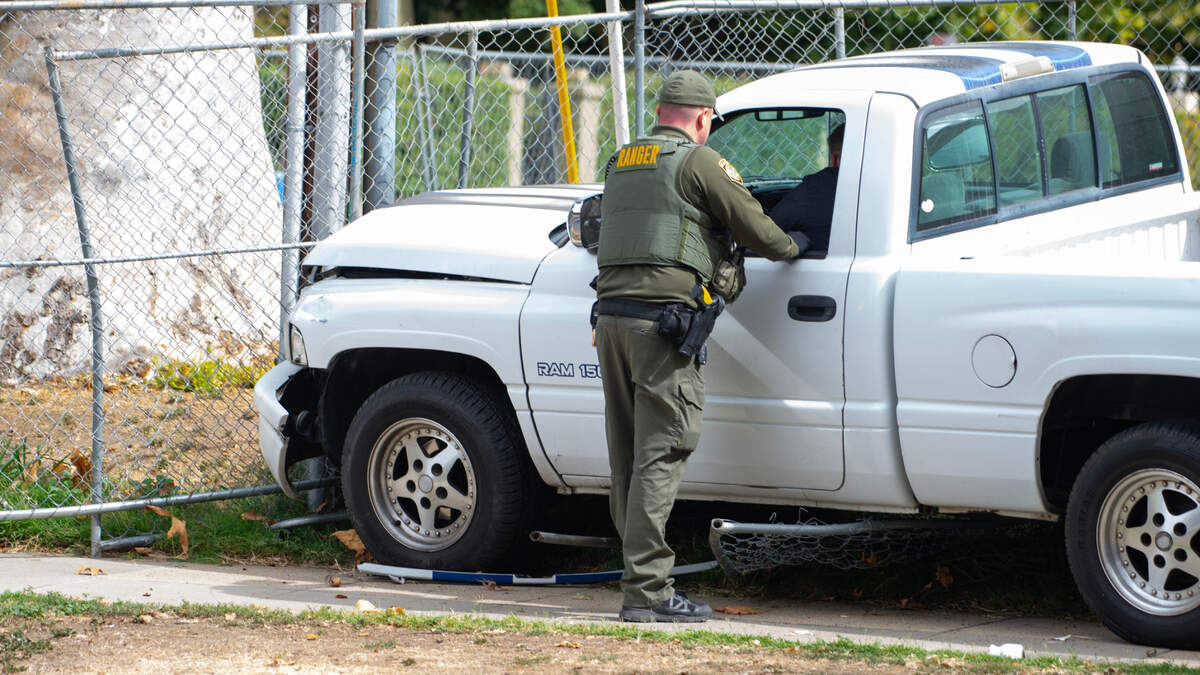 A Sacramento Park Ranger talks to the driver of a white Dodge truck that clipped a pedestrian on Alhambra Boulevard in Sacramento on Friday, Sept. 29, 2023.