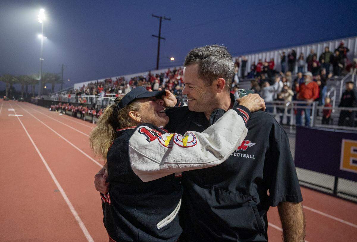 Winters Warriors coach Daniel Ward embraces his mother Robin Manna after the 28-7 victory over the Morse Tigers in the CIF Division 6-A State Championship football game at Buena Park High School in Buena Park on Saturday.