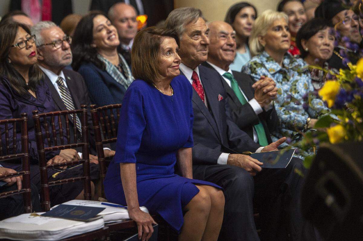 U.S. House Speaker Nancy Pelosi smiles as she is introduced on stage during the swearing in ceremony for Eleni Kounalakis as lieutenant governor of California at the Tsakopoulos Library Galleria on Jan. 7, 2019. Sitting next to her are husband Paul Pelosi and Angelo Tsakopoulos, who is Kounalakis’ father.