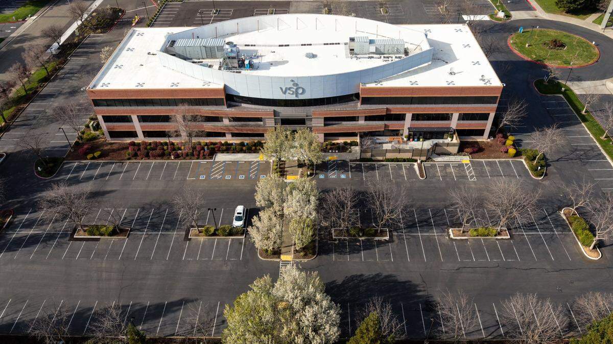 The VSP campus parking lot in Rancho Cordova is nearly empty in 2021. With much of its staff working remotely, the company has moved out of three of the five buildings.