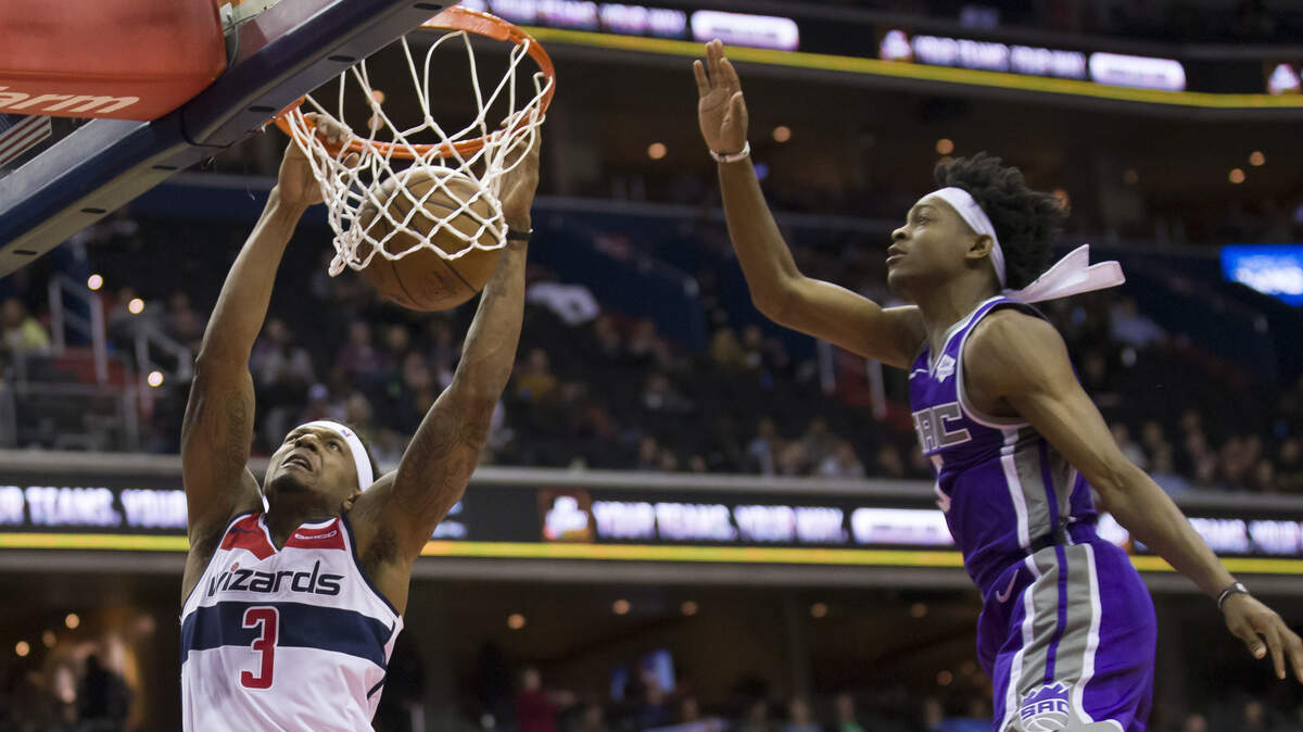 Washington Wizards guard Bradley Beal, left, and Kings guard De’Aaron Fox led their teams in scoring Monday at Capital One Arena in Washington.