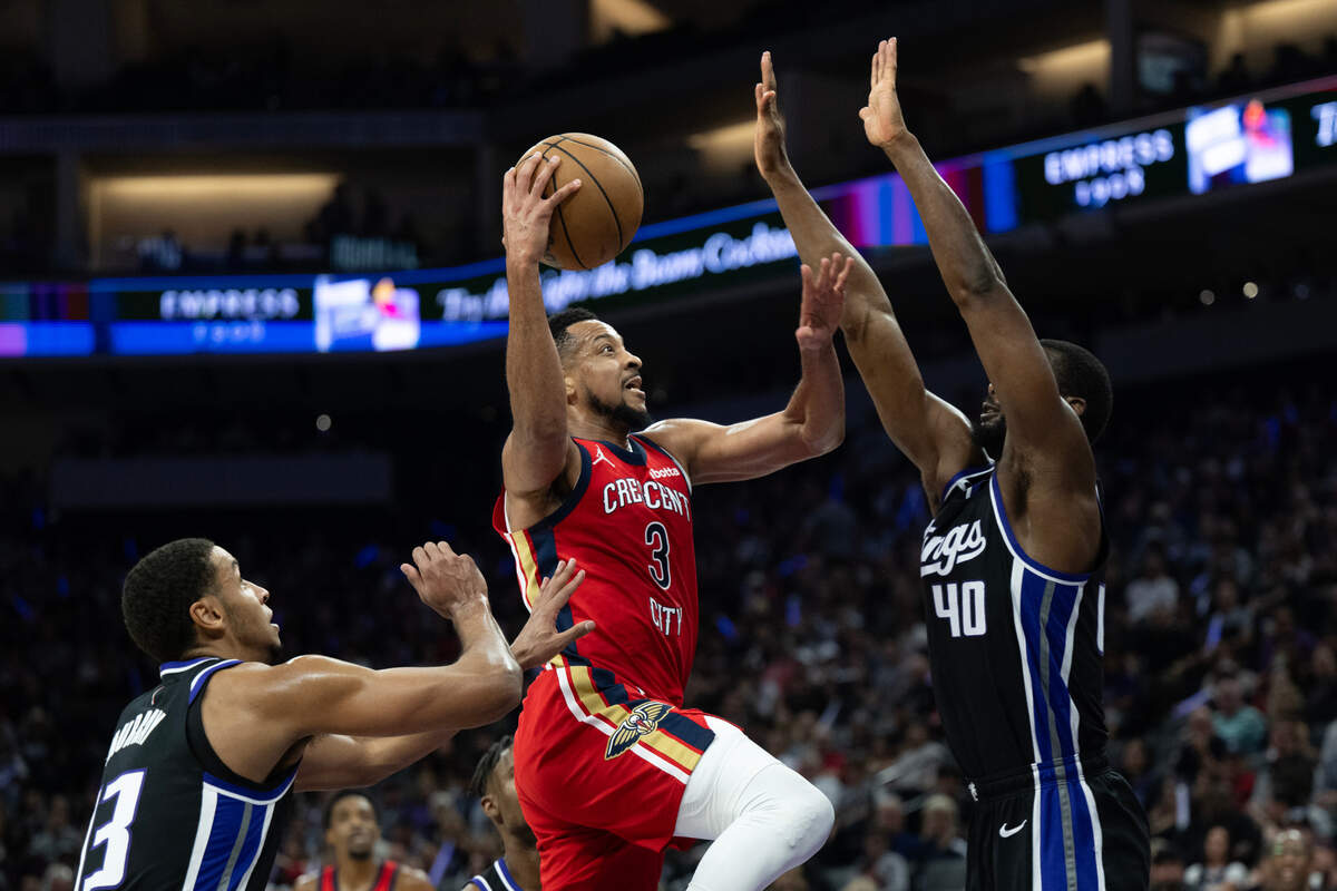 New Orleans Pelicans guard CJ McCollum (3) drives to basket against Sacramento Kings forward Harrison Barnes (40) and forward Keegan Murray (13) during a game Thursday at Golden 1 Center in Sacramento.