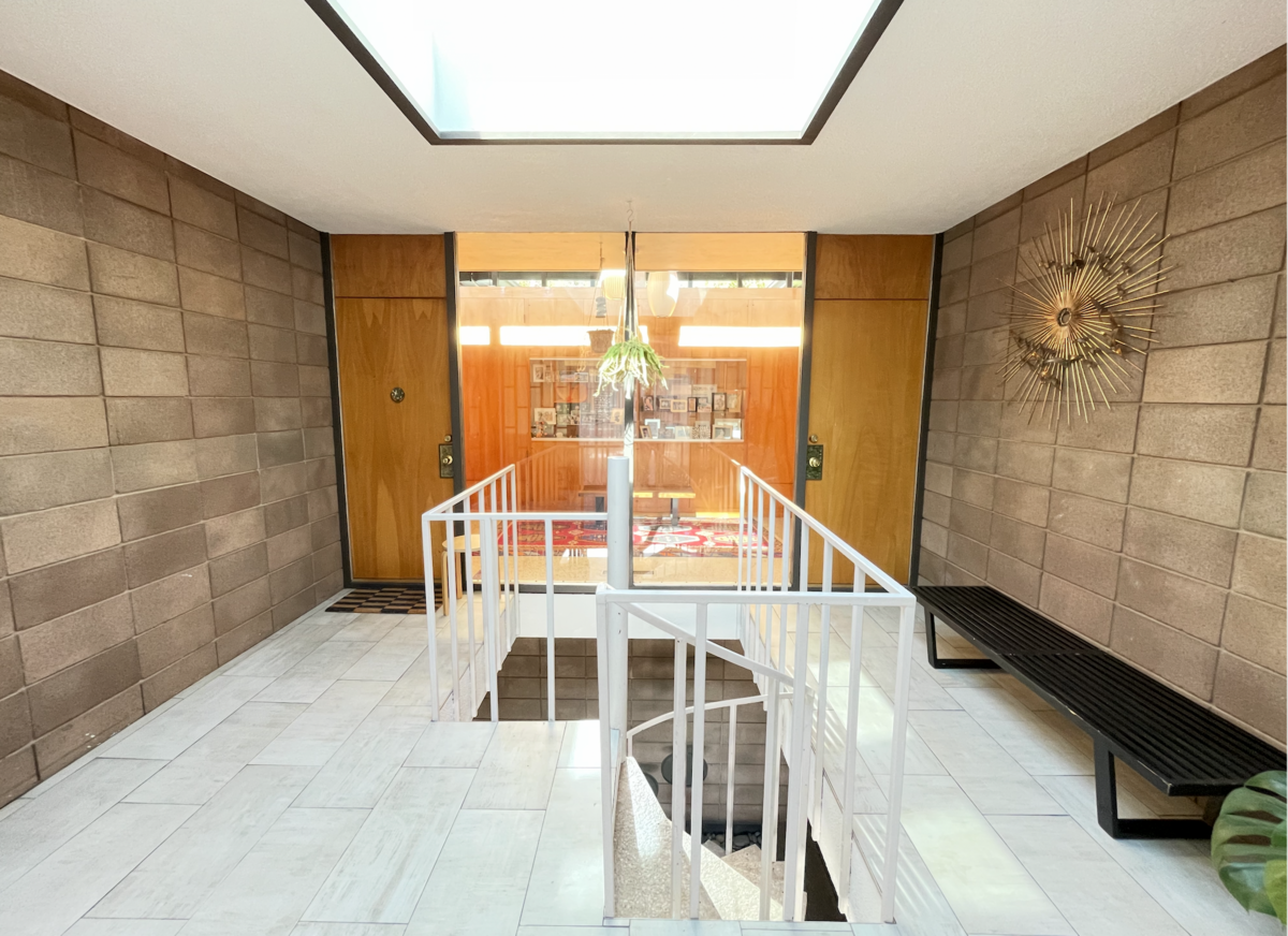 The courtyard entry features a staircase leading up to two front doors above.