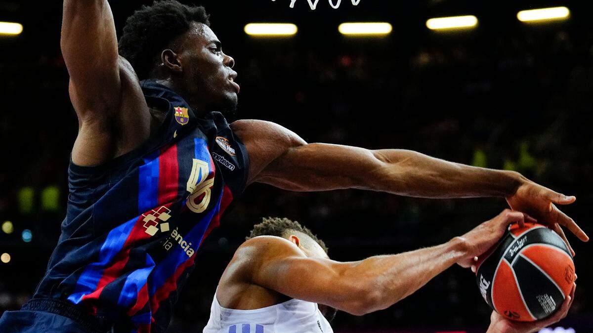 Barcelona’s James Nnaji (left) in action against Real Madrid’s Edy Tavares (right) during the Euroleague Final Four semifinal basketball match between Real Madrid and FC Barcelona on May 19, 2023, in Kaunas, Lithuania.