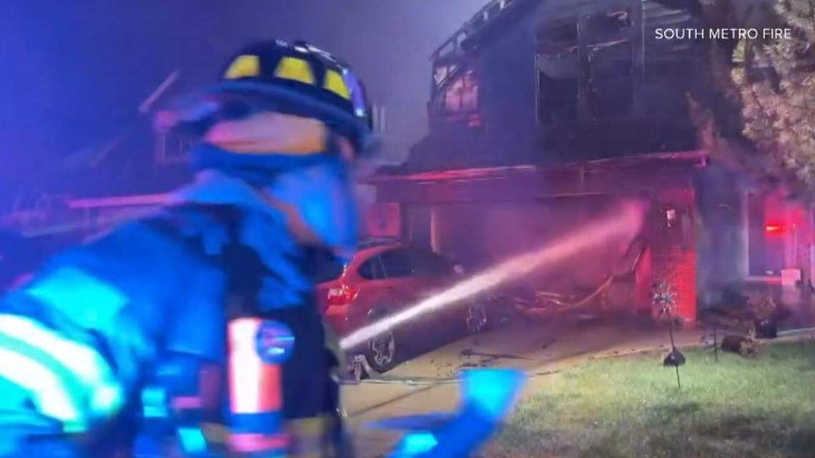 Fireworks placed in a recycling bin ignited a fire destroying two Denver homes and injuring a firefighter, Colorado officials say.