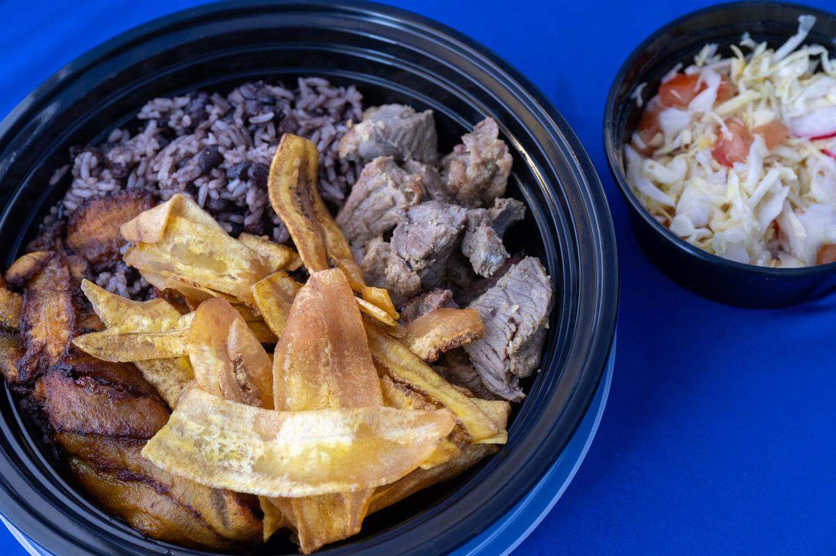 A Típico bowl served with pork, plantains rice and beans, and coleslaw at the TípicoNica pop-up stand on Monday, April 1, 2024, in Rancho Cordova.