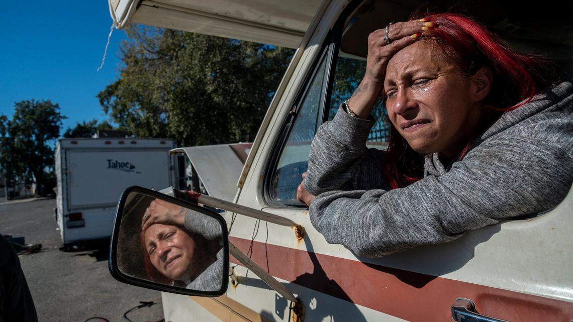 Jumper cables lay in the street as Lorraine Ramirez, 49, expresses frustration because her camper won’t start on Wednesday, Feb. 16, 2022, as Sacramento city crews tow vehicles from a homeless encampment on Evergreen Street on Wednesday, Feb. 16, 2022. Her son lives in the vehicle with her.