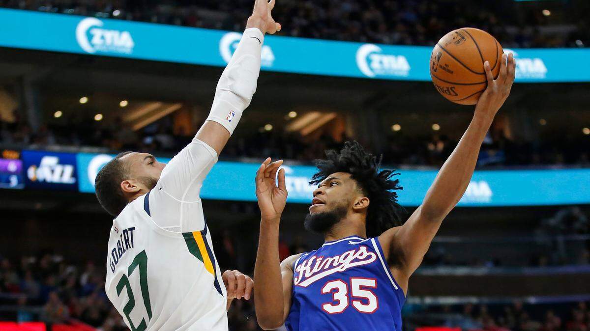 Utah Jazz center Rudy Gobert defends against Sacramento Kings forward Marvin Bagley III on Saturday night in Salt Lake City.