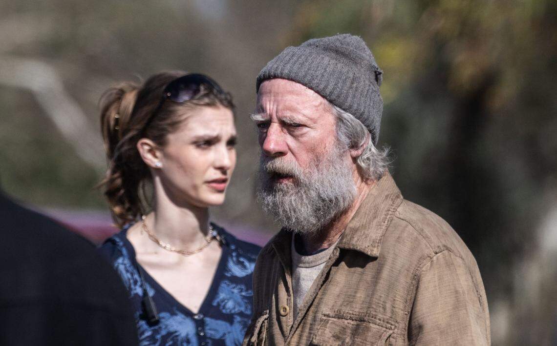 Actor Xander Berkeley, right, waits for the next scene to be filmed for the movie “No Address” in Sacramento’s William Land Park in March 2023. Berkeley plays the leader of a homeless group who is a war veteran and former addict.