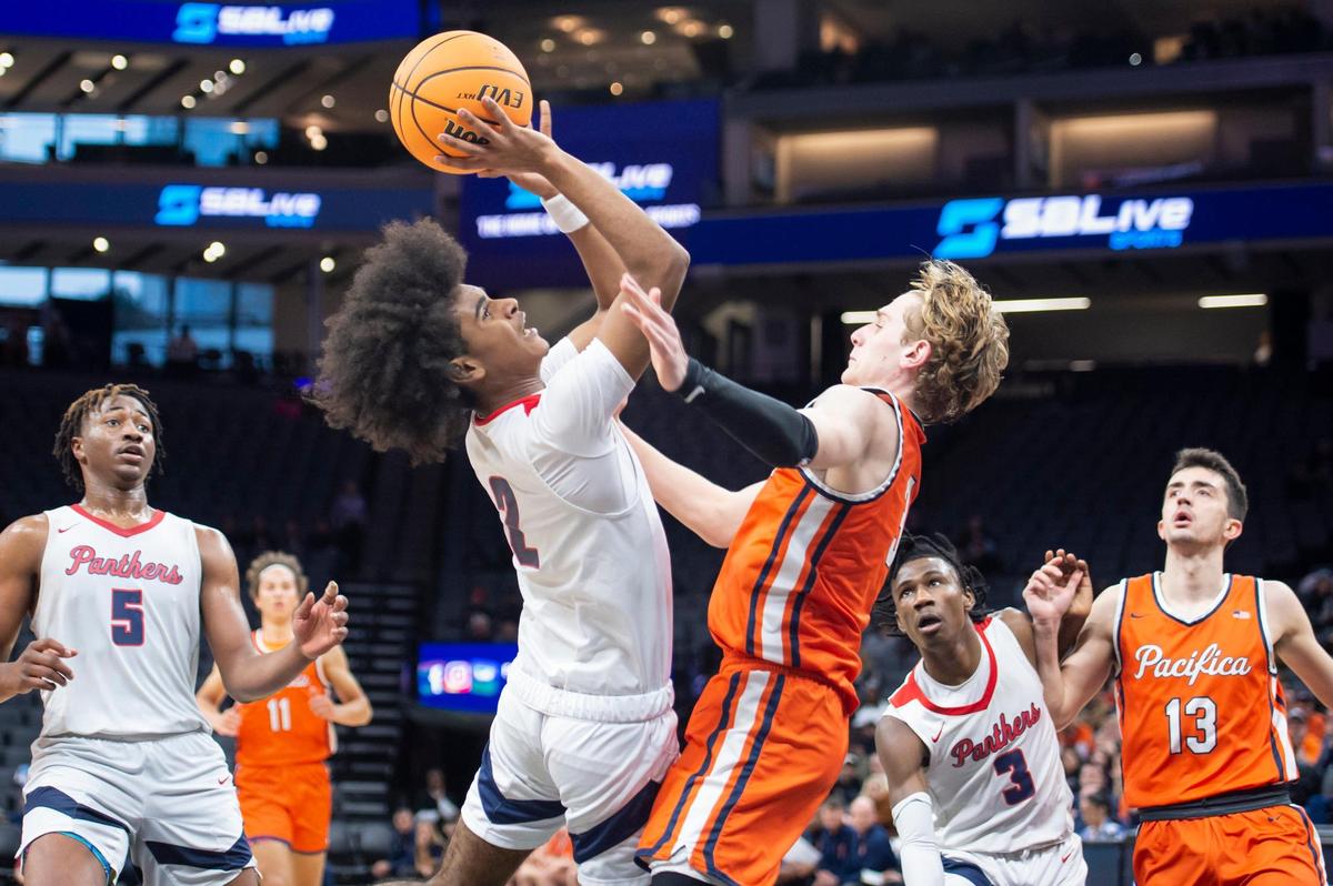 San Joaquin Memorial Panthers guard Abram Potts (2) draws the foul on Pacifica Christian Tritons Parker Strauss (3) and makes on of the free throws in the CIF State Division II Boys Basketball Championship on Saturday, March 11, 2023, at Golden 1 Center in Sacramento. The Panthers defeated the Tritons 58-47.