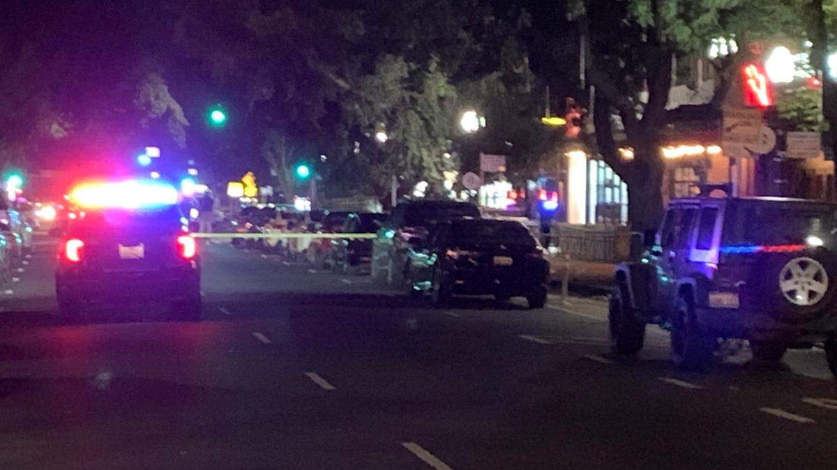 Police are seen on J Street between 27th and 28th streets Sunday, Sept. 25, 2022, following a shooting in the midtown section of Sacramento, Calif. One person was killed in the shooting along a popular block just before 1 a.m.