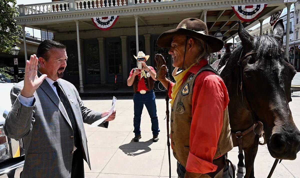 Sacramento Postmaster Douglas Smith swears in Steve Pool, who rode the first leg of Pony Express re-ride from Old Sacramento on Wednesday, June 16. The express ride returns after taking a year off during COVID.