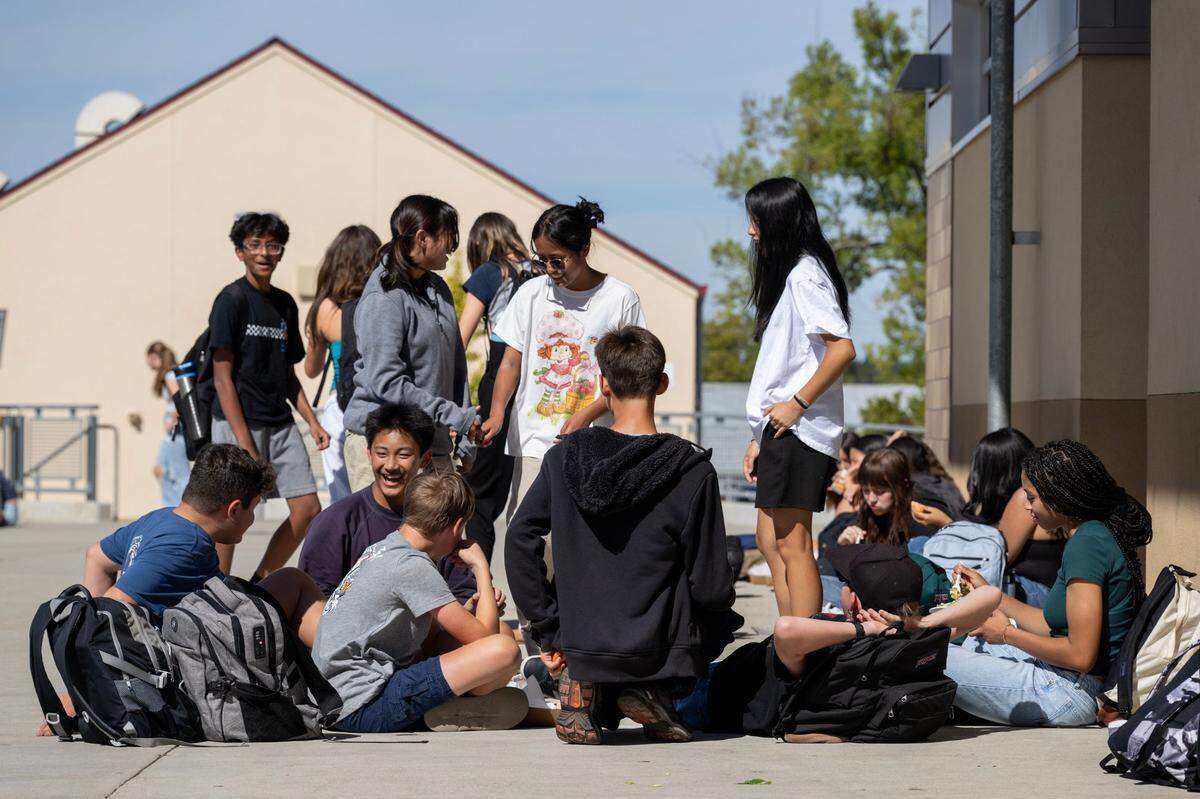 Students socialize during lunch at Sutter Middle School in Folsom earlier this month. The school has banned cell phones during school hours, including lunch, since 2022.