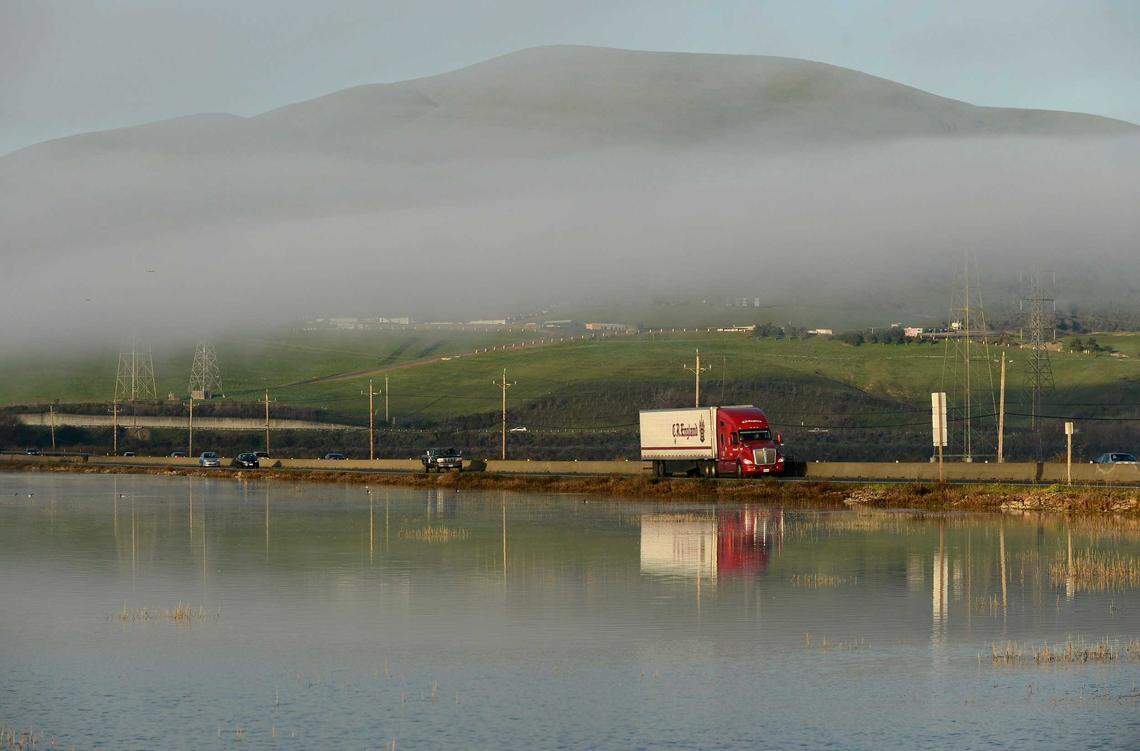 Traffic on Highway 37 passes Sears Point in January 2022. The two-lane section of the highway through this marshland is the focus of a widening project that does not include long-term protections against rising seas.