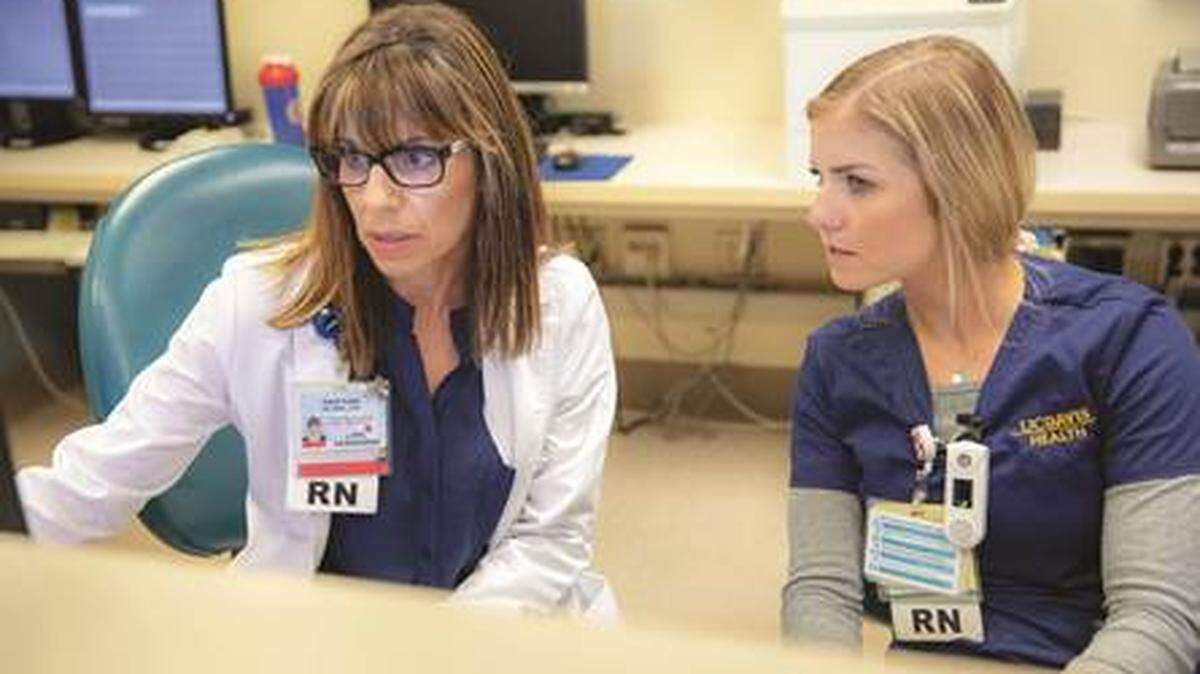 UC Davis Health nurse Carol Leija, left, consults with colleague Emily Becker in the oncology nurse navigator program.