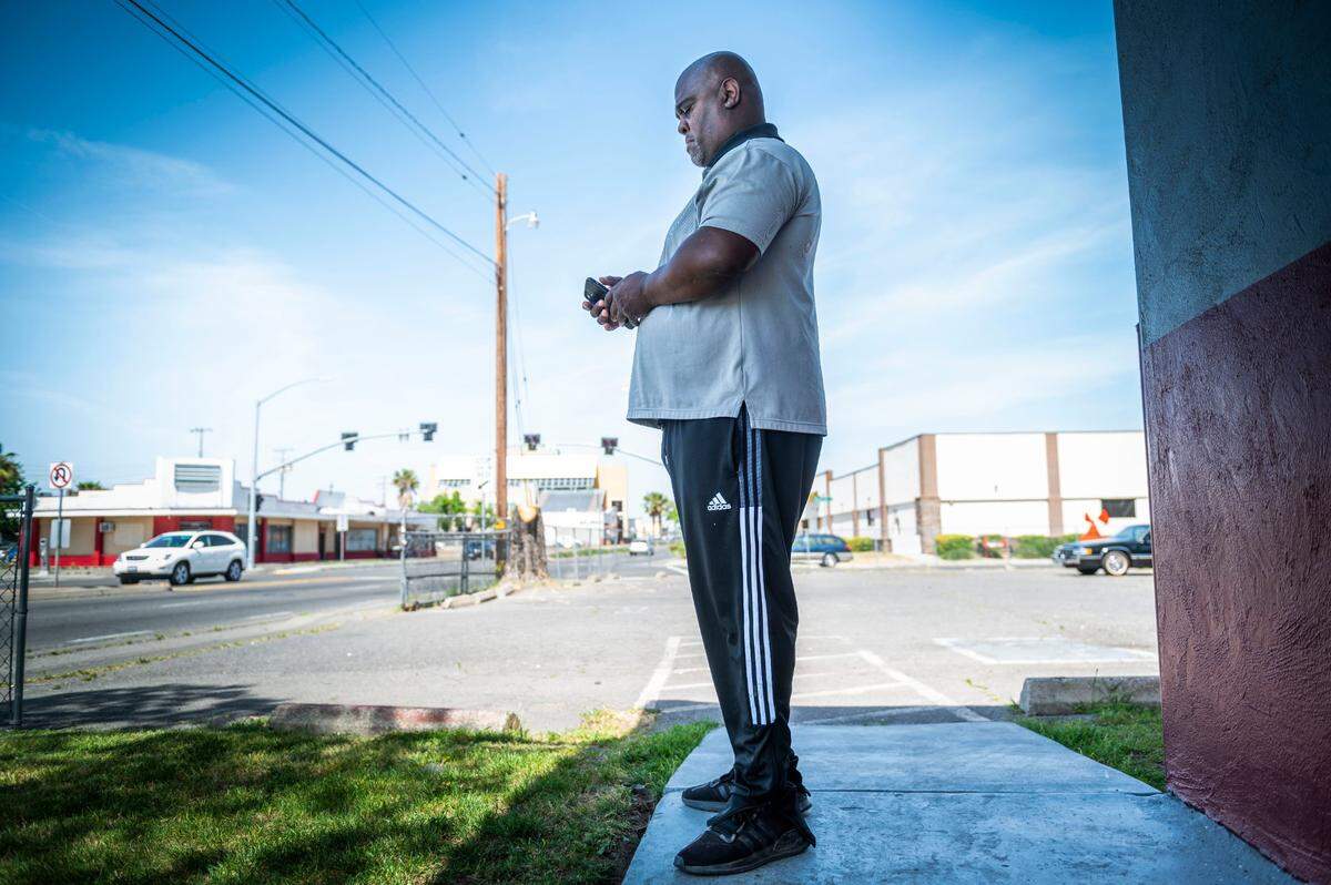 Brother 2 Brother founder Mervin Brookins looks at his phone outside his E24 Lounge in Del Paso Heights on Thursday after talking about Sunday’s shooting in downtown Sacramento. Brookings said that his organization needs help from the city and the public to keep young people out of trouble.