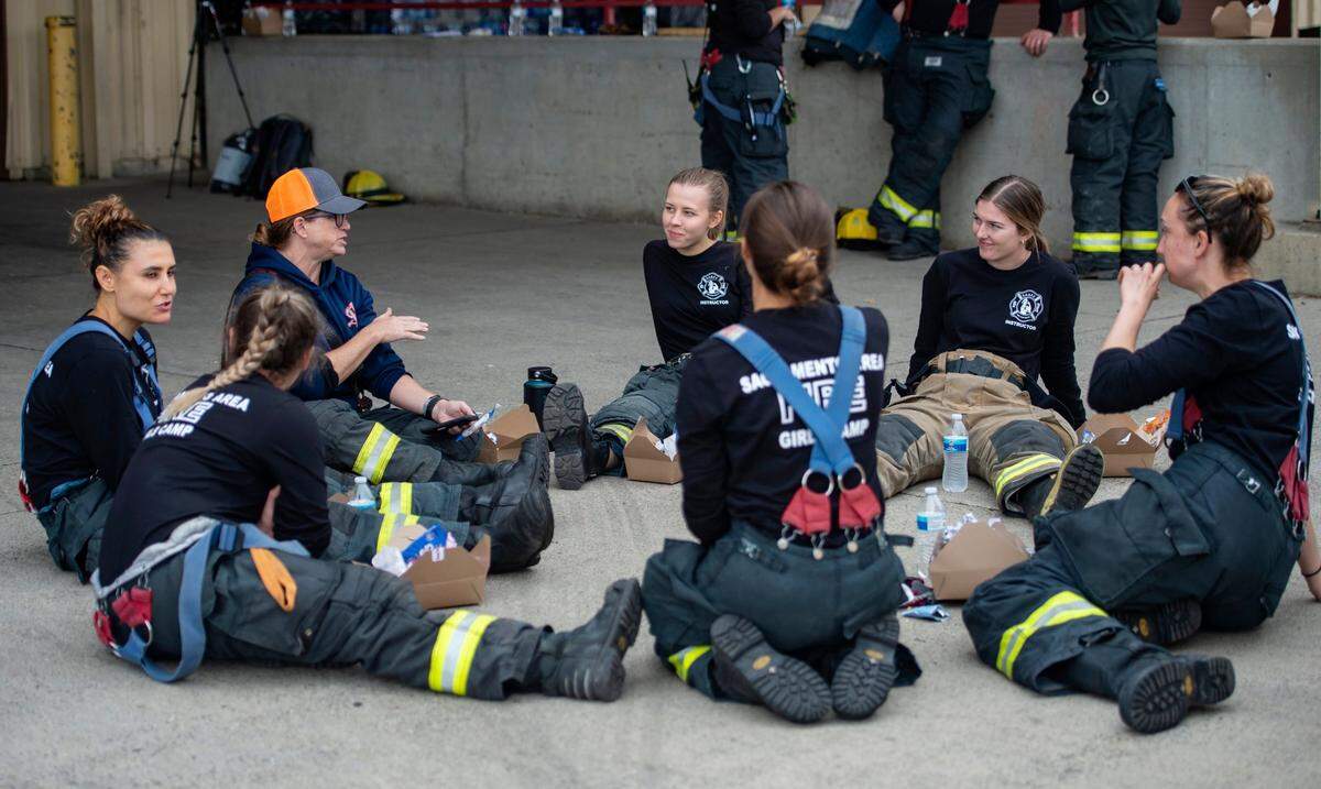 The firefighter instructors hang out during the lunch break at the Sacramento Area Girls Fire Camp at McClellan Park in October. In addition to mentoring girls, the camp creates a sisterhood for female firefighters, according to an attendee, which make up about 6% of the profession in California.