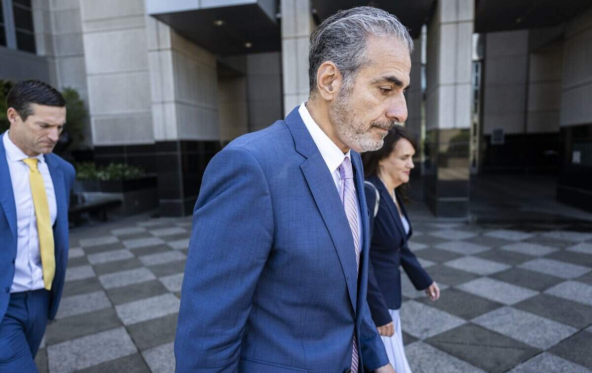Former Sacramento City Councilmember Sean Loloee, center, leaves the Robert T. Matsui United States Courthouse in Sacramento on Thursday after he pleaded guilty to charges involving fraud, tax violations and underpaying immigrant workers at his Viva Supermarket stores.