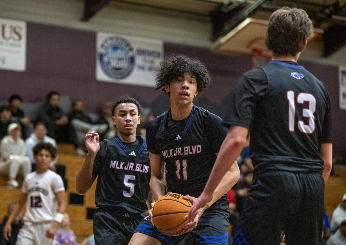 Christian Brothers' Jaden DeJesus-Eves (11) rebounds a ball between Joaquin Lucero-mattis (5) and Braeden Hennelly (13) in the first half against the Woodcreek Timberwolves on Thursday, Jan. 8, 2026 in Roseville.