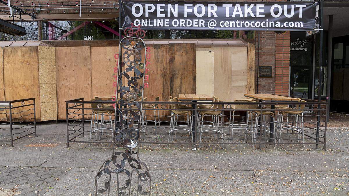Plywood protects the windows of Centro Cocina Mexicana on J Street in downtown Sacramento that has temporarily closed during the coronavirus pandemic on Wednesday, April 8, 2020.