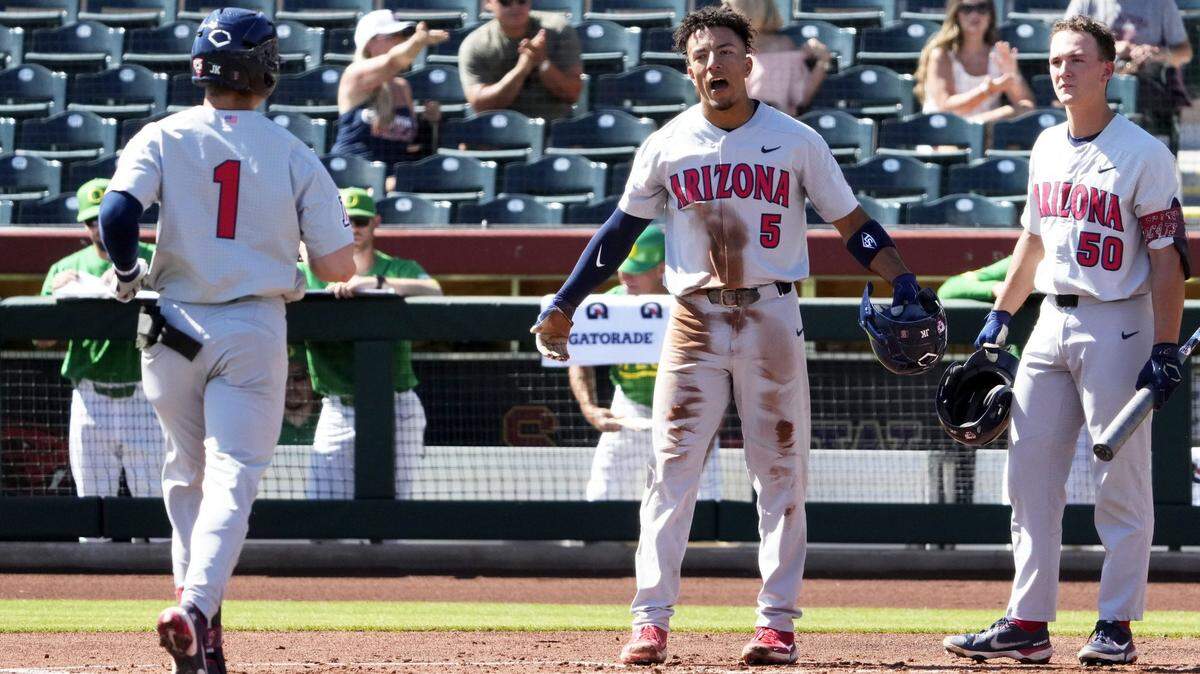 The Arizona Wildcats’ Chase Davis (5) reacts after Garen Caulfield (1) hit a two-run home run against the Oregon Ducks in the second inning during the Pac-12 Baseball Tournament at Scottsdale Stadium on May 25, 2022.