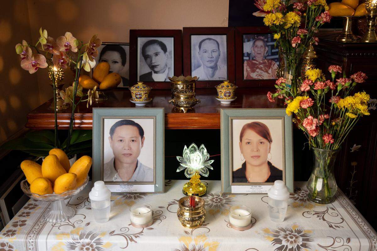 An altar holds photographs of Binh Nguyen, 55, and his wife Tien Thuy Le, 47, along with other ancestors, in the living room of his mother’s house, where the couple’s young children now reside. The couple was out for coffee on a Saturday morning in May when a suspect fleeing police hit their vehicle, killing them.