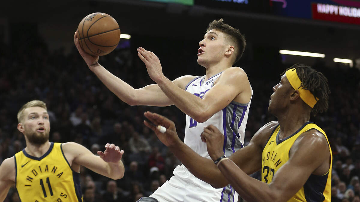 Kings guard Bogdan Bogdanovic, center, scored a team-high 20 points off the bench in a 111-110 victory over Domantas Sabonis, left, Myles Turner and the Indiana Pacers on Saturday at Golden 1 Center.