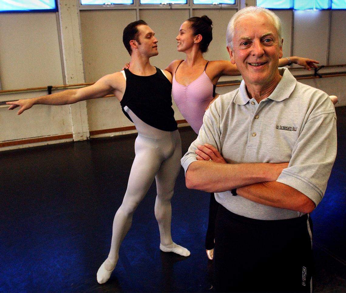 Sacramento Ballet Artistic Director Ron Cunningham stands in front of dancers Jack Hansen and Sarah Hinman at the ballet’s studios in 2003. 