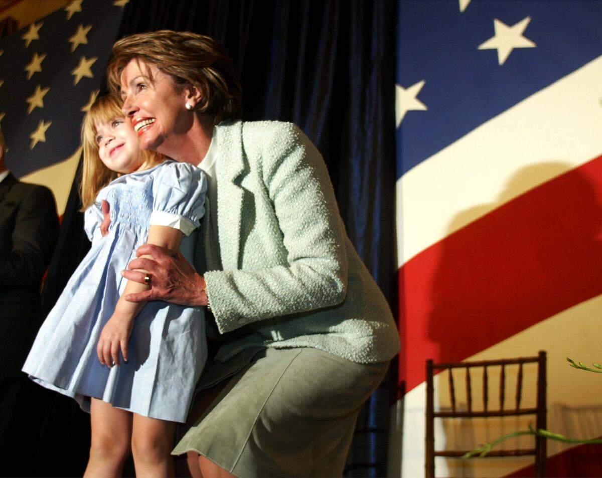 New House Democratic leader Nancy Pelosi, D-Calif., hugs her granddaughter during her swearing in ceremony Jan. 7, 2003, on Capitol Hill in Washington, D.C. This is the first day of the 108th Congress and members of the House of Representatives will be sworn in and leadership elections will be held. 