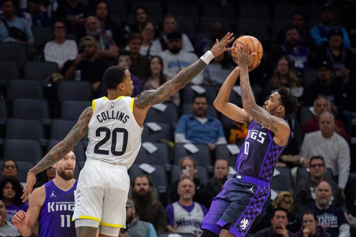 Utah Jazz forward John Collins (20) blocks the shot of Sacramento Kings guard Malik Monk (0) in the first half on Sunday, Dec. 8, 2024, at the Golden 1 Center.
