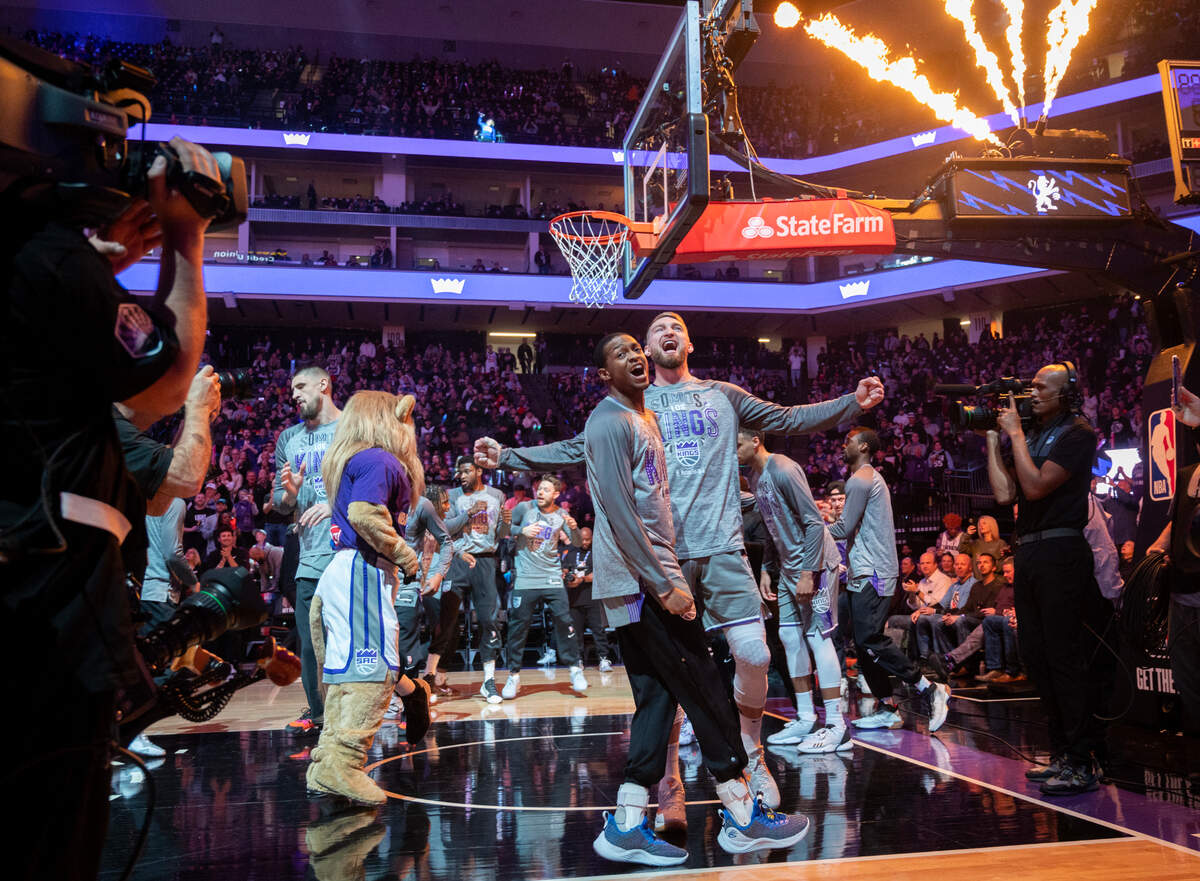 Sacramento Kings guard De’Aaron Fox and forward Domantas Sabonis bump chests during the pregame introduction at Golden 1 Center on Thursday, March 9, 2023.