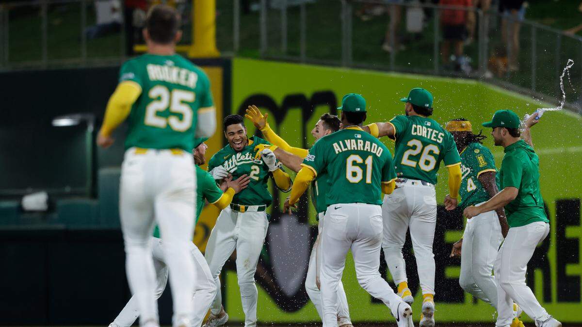 Athletics third baseman Darell Hernaiz (2) celebrates with teammates after winning the game with a bases loaded walk-off walk during the 10th inning Tuesday against the Detroit Tigers at Sutter Health Park in West Sacramento.