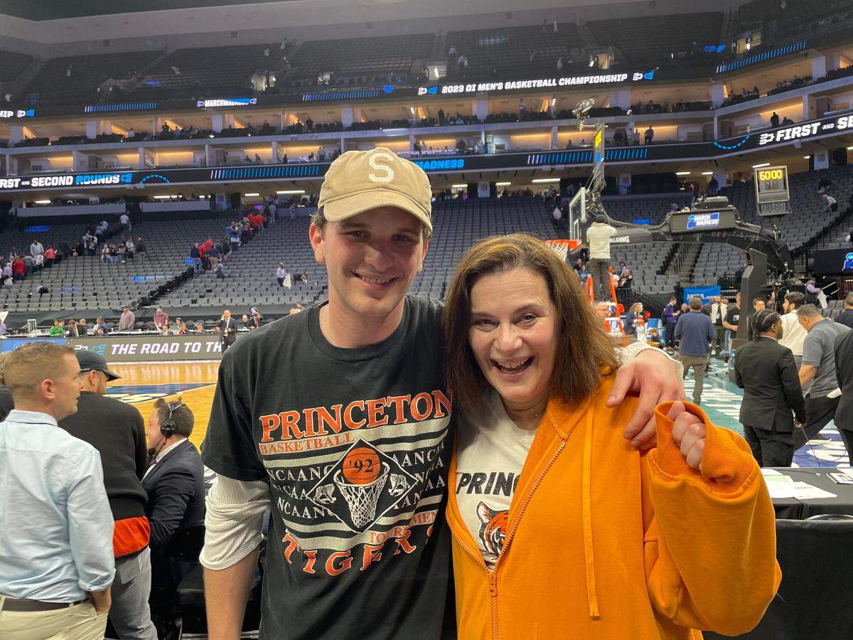 Jess Deutsch, a Princeton fan and alum, poses with her son after watching Princeton play Arizona in the first round of the men’s NCAA basketball tournament on Thursday, March 16, 2023. Deutsch works for Princeton as an associate director for student-athlete services and flew into Sacramento from New Jersey late Wednesday night. She said she never doubted that the No. 15-seeded Tigers could beat the No. 2-seeded Wildcats, which they eventually did with a final score of 59-55.
