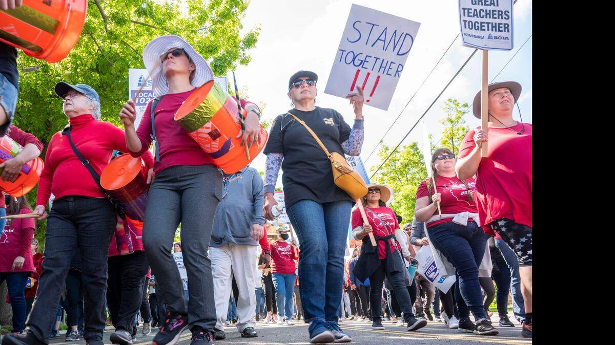 Participants of a march and rally at Hiram Johnson High School walk to the Transportation office on Tuesday, March 29, 2022 in Sacramento during the SCTA and SEIU Local 1021 strike.